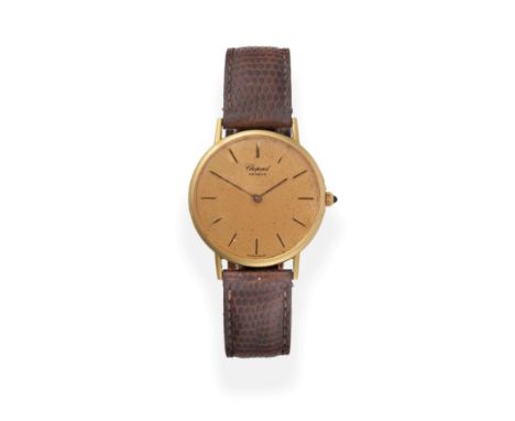 An 18ct Gold Wristwatch, signed Chopard, circa 1990, quartz movement, gold coloured dial with baton markers, snap-on back num