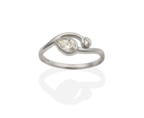 An 18 Carat White Gold Diamond Two Stone Cross Over Ring, a pear cut diamond and a round brilliant cut diamond in rubbed over