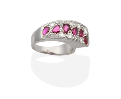 A 9 Carat White Gold Ruby and Diamond Ring, a tapering plaque pavé set with pear cut rubies and round brilliant cut diamonds,