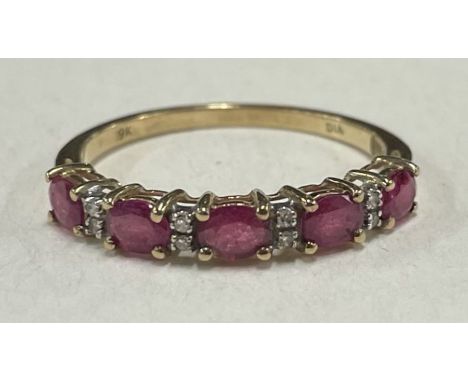 A ruby and diamond half eternity ring in 9 carat. Approx. 1.6 grams. Est. £30 - £50.