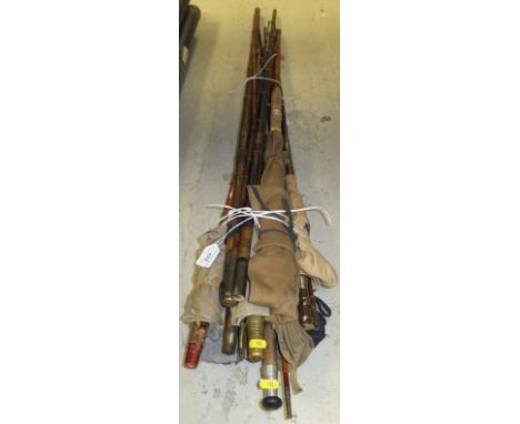 A collection of approximately 11 vintage wooden, split cane and fibreglass fishing rods, some named