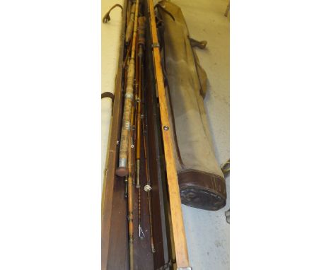A large pine rod case containing a good selection of vintage fishing rods, to include examples by Allcocks and Hardy, etc, to