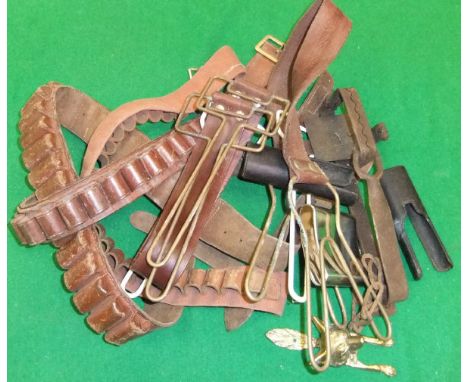 A box containing three various cartridge belts, three game carriers, gin trap, hip flask, fox door knocker and two 12 bore si