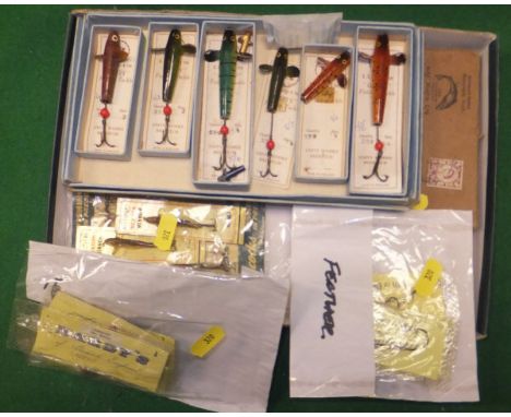 A collection of vintage fishing lures to include four carded and packeted Hardy's spinners, five Hardy packeted and carded ho
