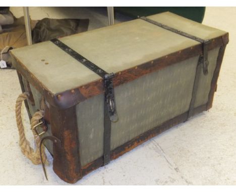 A vintage canvas covered cane picnic basket with metal bindings