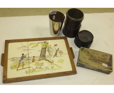 A leather cased collection of plated hunting beakers, a plated sandwich tin, and an oak framed tiled tray decorated with a hu