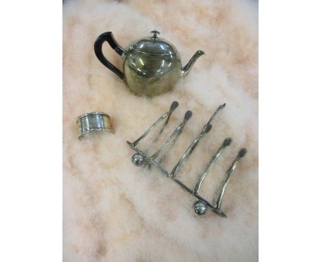 A white metal napkin ring, a bachelor's teapot and toast rack 