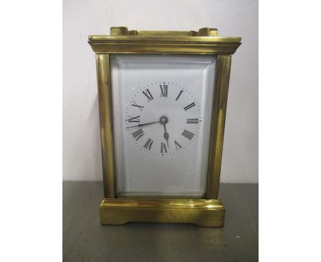 An early 20th century brass cased carriage clock having white enamel dial and blued hands 