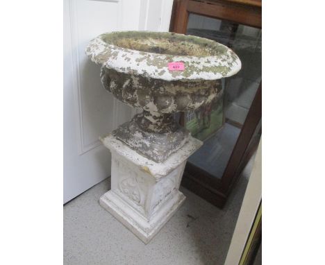 A white painted garden planter raised on a square base 32"h x 20"w 