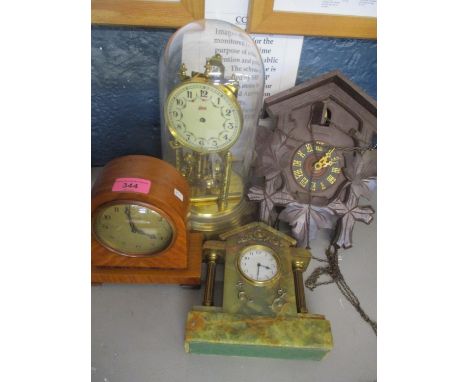 Four clocks to include a cuckoo clock, anniversary clock and two mantle clocks 