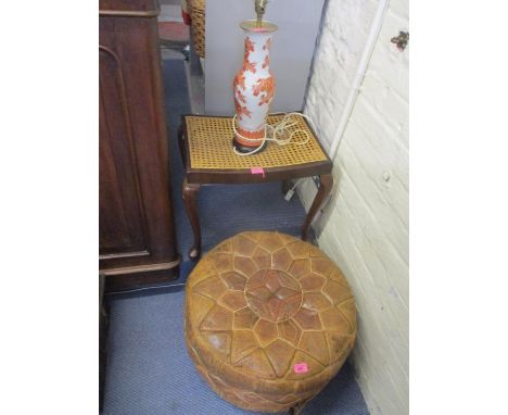 An Egyptian style leather pouffe, a mahogany and cane footstool and a late 20th century oriental style table lamp 