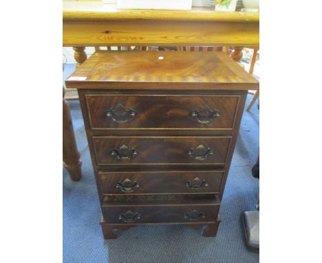A reproduction mahogany small chest of four drawers on bracket shaped feet, 25" h x 17 1/2" w 