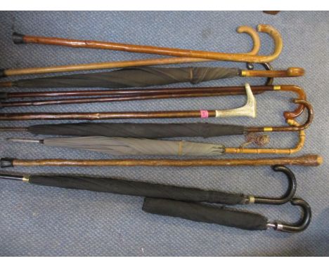 A quantity of walking sticks and vintage umbrellas 