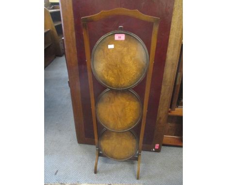 An early 20th century walnut three tier cake stand 