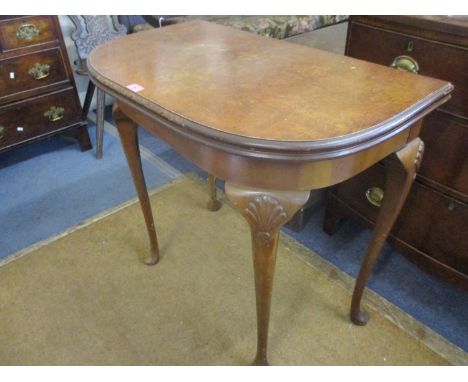 A mid 20th century burr walnut card table, with a foldover top on cabriole legs 