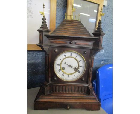 A late 19th century mahogany mantle clock of architectural form having flat shaped finials and white enamel dial with Roman n