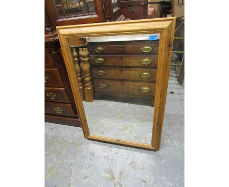 A modern pine framed wall mirror, 34 1/2" x 24 5/8", a pair of contemporary prints and another, along with a brass effect sta