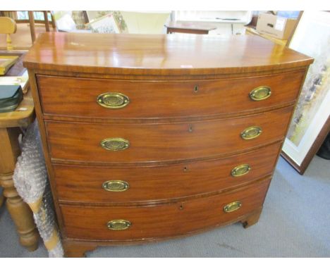 An early 20th century bow fronted mahogany chest of four graduating drawers on bracket feet 