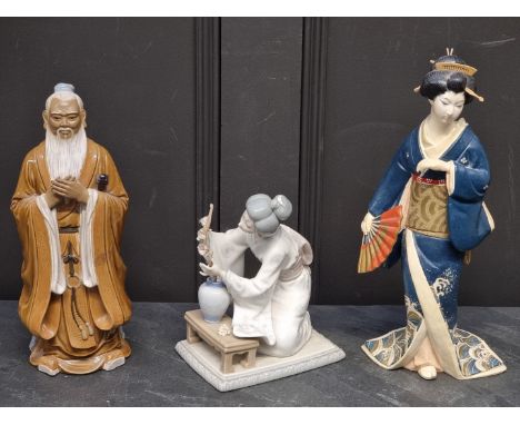 A Lladro porcelain figure, 19.5cm high; together with a Chinese Shiwan figure, 30cm high; and another pottery figure of a Gei