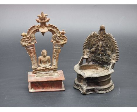 An Indian bronze oil lamp; together with a small brass Buddha, 16.5cm high. (2)