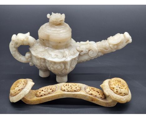 A Chinese carved jade teapot and cover, in Han style, 14.5cm high; together with another jade ruyi sceptre, 24cm long. (2)