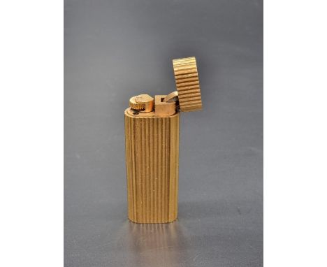 A Cartier gold plated ribbed lighter,&nbsp;7cm.