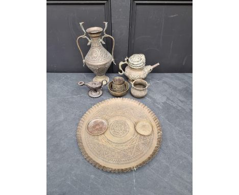 A small collection of Islamic brassware; together with a small Roman style cast iron oil lamp. 