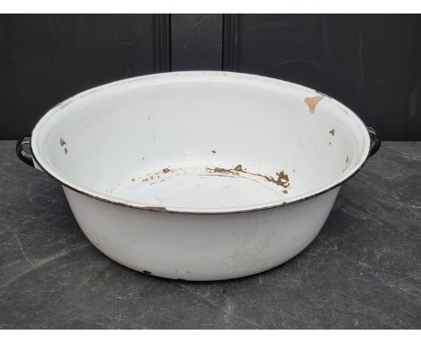 A large enamel twin handled basin, 55cm wide.