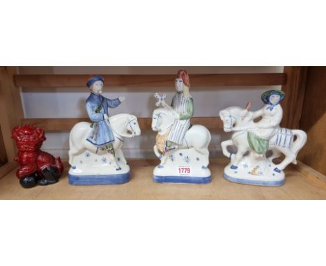 A Royal Doulton flambe 'Dog of Fo', 12.5cm high; together with three Rye Pottery 'Canterbury Tales' figures. (4)