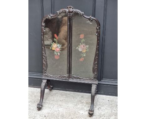 A circa 1900 carved walnut triptych fire screen, on paw feet, pained with flowers, 110.5cm high x 122cm wide.