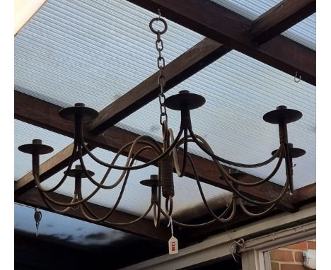 A steel eight branch chandelier, for candles, 77cm diameter.