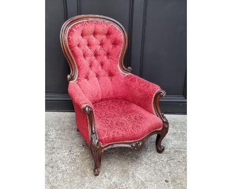 A Victorian carved mahogany and button upholstered occasional armchair. 