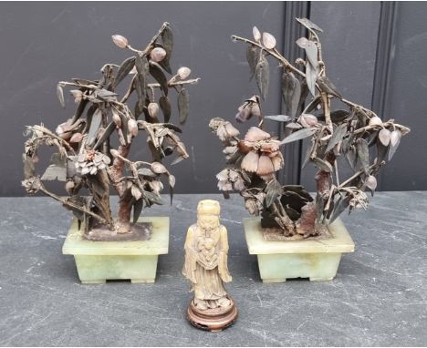 A pair of Chinese jade and hardstone tree ornaments, 28cm high; together with a soapstone figure, on wood stand, 13cm high. (