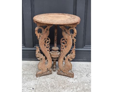 An Eastern carved hardwood circular tripod table, 45cm diameter.
