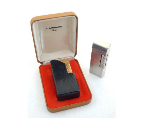 A Dunhill rollagas lighter, with an engine turned silver plated case, together with a Flaminaire lighted, gold plated with bo