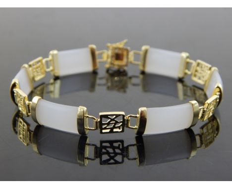A Chinese white jade bracelet, with symbol decoration. 