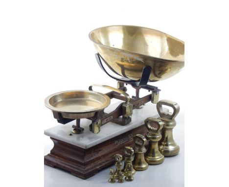 A pair of early 20th century scales, by Wedderburn of Southampton, with brass pans, white marble top and oak base, together w
