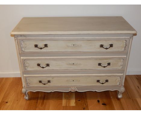 A French provincial style grey and cream painted commode, fitted three drawers on short cabriole legs. W. 108cm