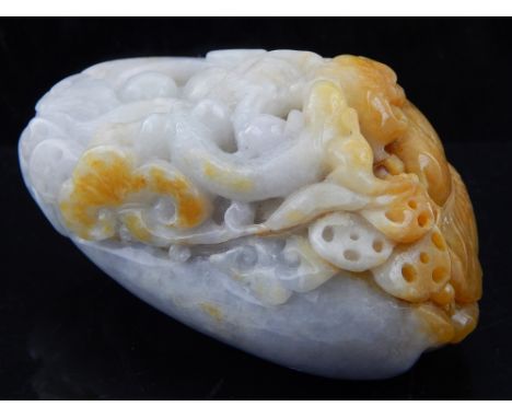 A Chinese jade paperweight, carved with scrolling foliage and mythical beast. L. 9cm
