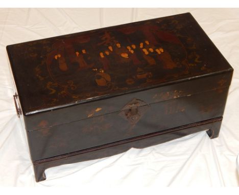 A 20th century Chinese lacquer trunk on stand, the rectangular top decorated with noble figures in an interior, with drop han