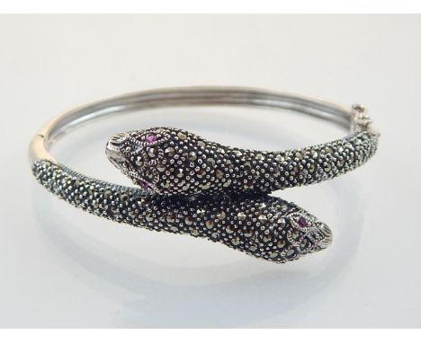 A white metal and marcasite bangle, fashioned as two snakes. internal diam. 5.5cm