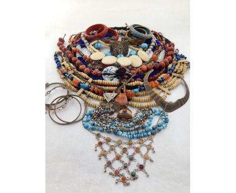 A quantity of costume jewellery, to include bone necklaces, a filigree white metal bangle, beaded necklaces, bakelite bangles