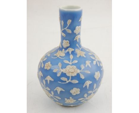 A Chinese light blue glazed baluster vase with elongated neck, relief decorated with flowers and butterflies, bears mark to b