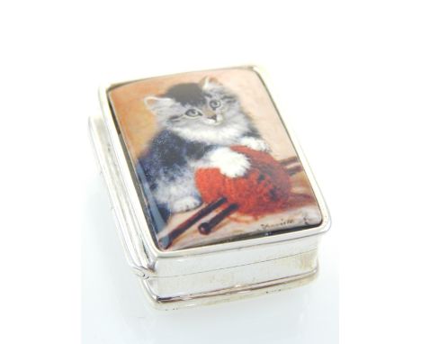 A silver pill box, the hinged lid having an enamel plaque depicting a kitten playing with a ball of wool. L. 3cm