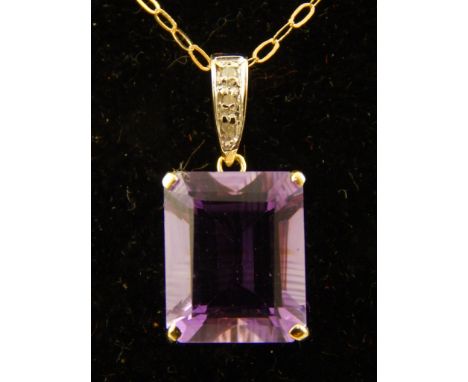 A 9ct yellow gold, emerald cut amethyst and diamond pendant, suspended on a 9ct gold chain. 