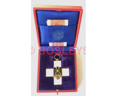 German Third Reich Cased Red Cross Decoration 2nd Class by GebrŸder Godet & Co. Berlin. A good breast badge example in gilt a
