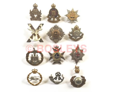 12 assorted Officer's cap badges. Intelligence Corps KC ... RAOC enamelled KC ... East Anglian Brigade ... Highland Brigade .