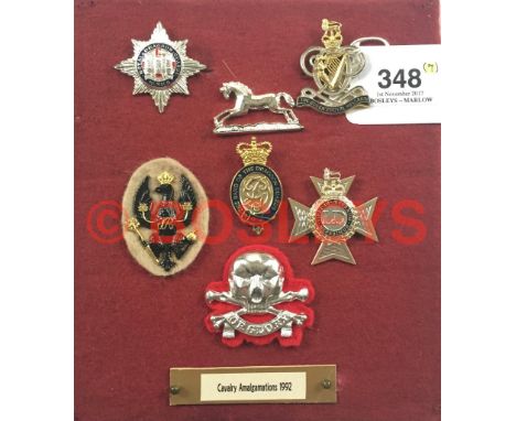 Cavalry Amalgamations 1992 cap badges. Display of the seven regiments, many enamelled. All complete with fixings, (Harp secur