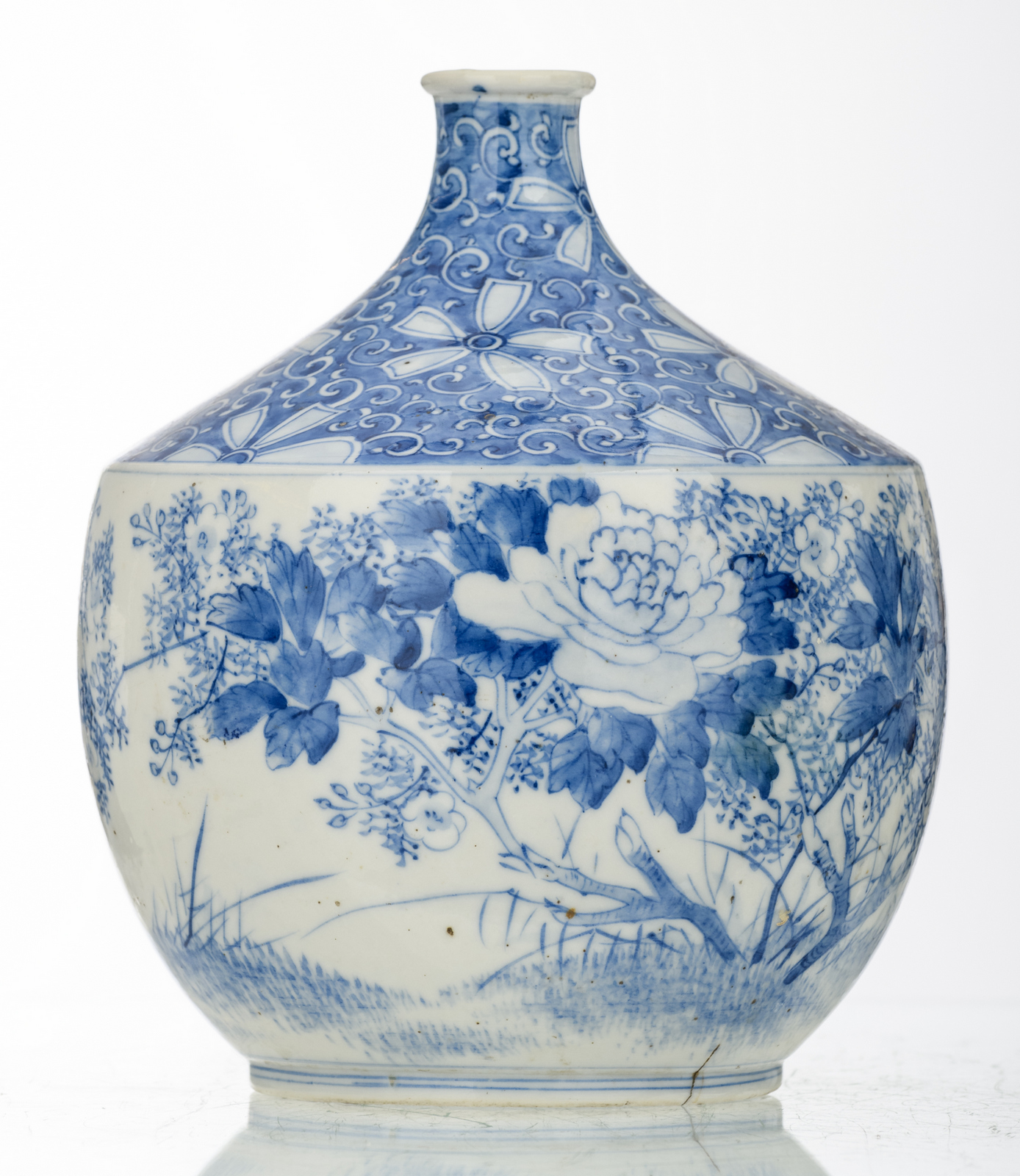 A Japanese blue and white decorated vase with flower branches and a