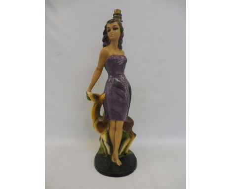 A tall 1950s/1960s plaster figure in the form of a lady forming a lamp. 